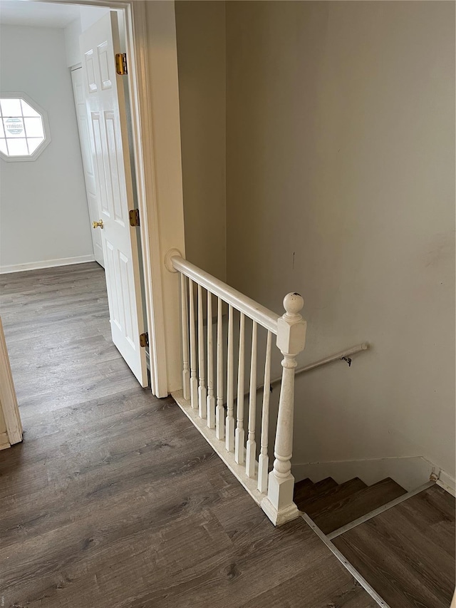 stairs with baseboards and wood finished floors