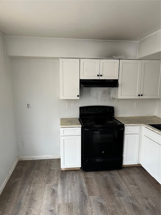 kitchen with electric range, dark wood-style floors, light countertops, white cabinetry, and under cabinet range hood
