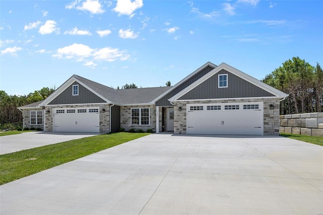 view of front facade with board and batten siding, driveway, and stone siding