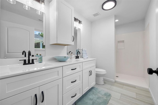 full bath with visible vents, double vanity, toilet, a walk in shower, and a sink