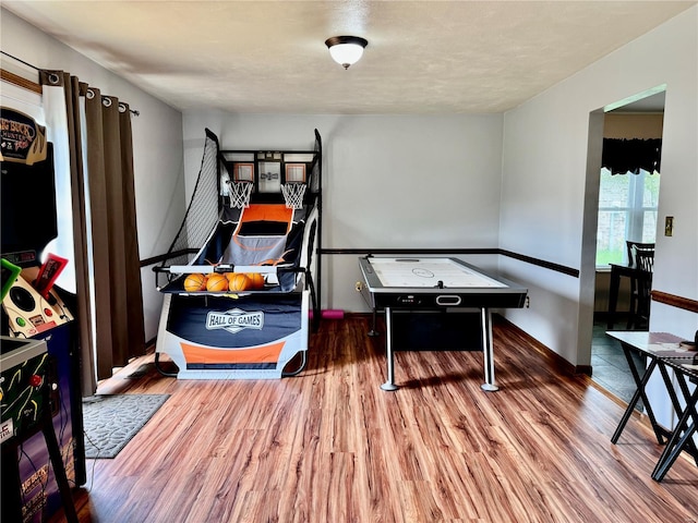 rec room featuring baseboards and wood finished floors