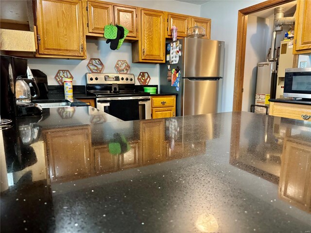 kitchen with brown cabinetry, gas water heater, and stainless steel appliances