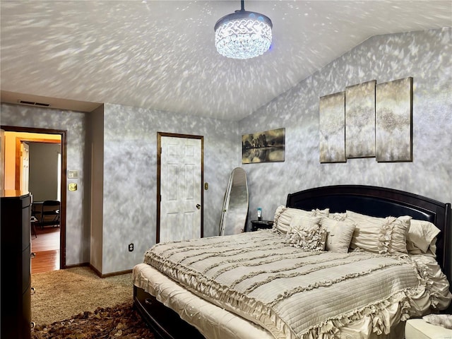 carpeted bedroom with baseboards, vaulted ceiling, and visible vents