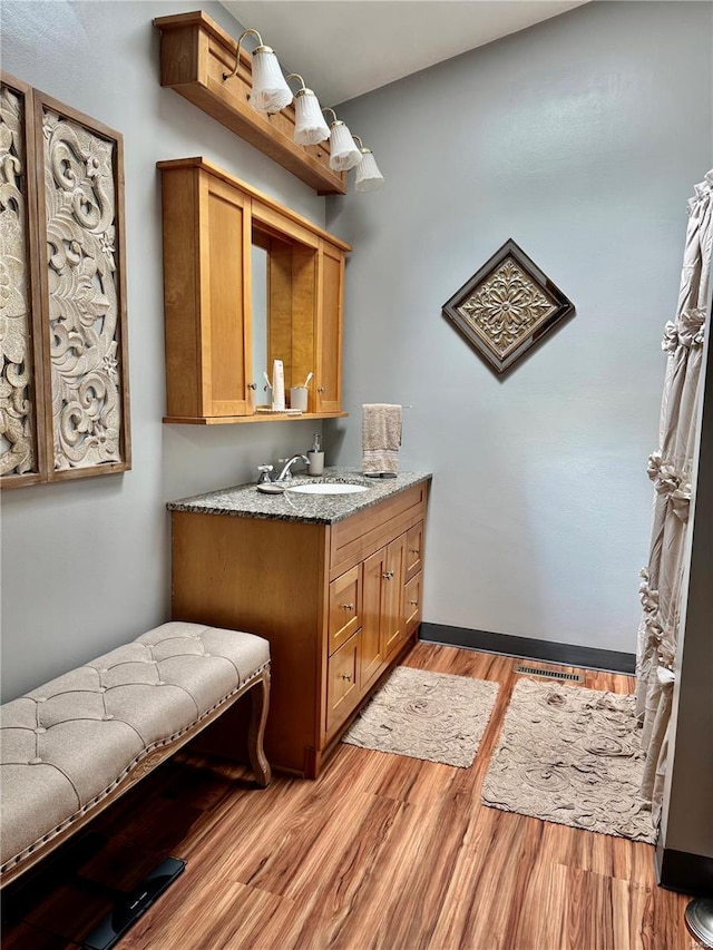 bathroom featuring vanity, wood finished floors, and visible vents
