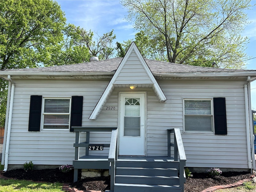 view of front of property featuring roof with shingles