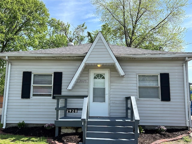 view of front of property featuring roof with shingles
