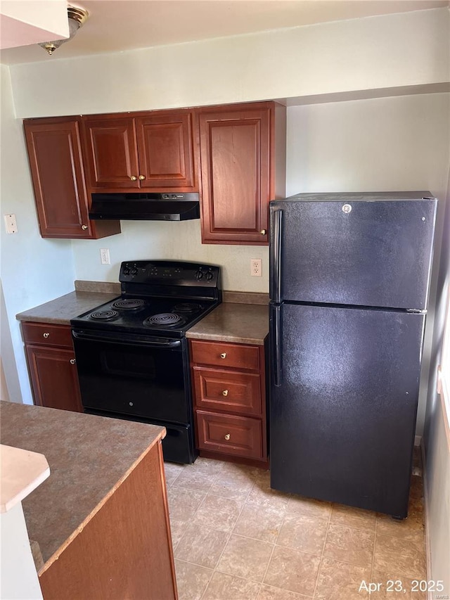 kitchen featuring brown cabinetry, under cabinet range hood, black appliances, and dark countertops