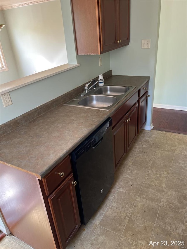 kitchen featuring baseboards, a sink, dishwasher, and dark countertops