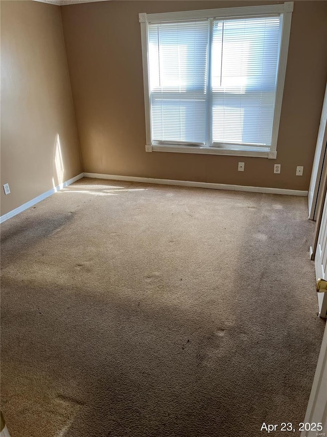 spare room with carpet flooring and baseboards