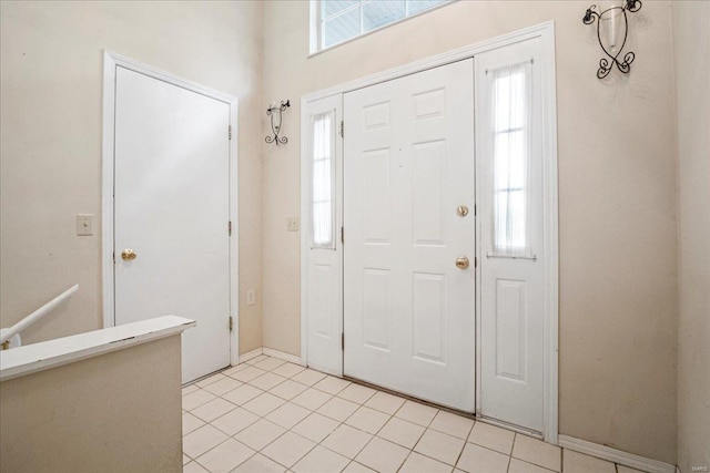 entryway with light tile patterned flooring
