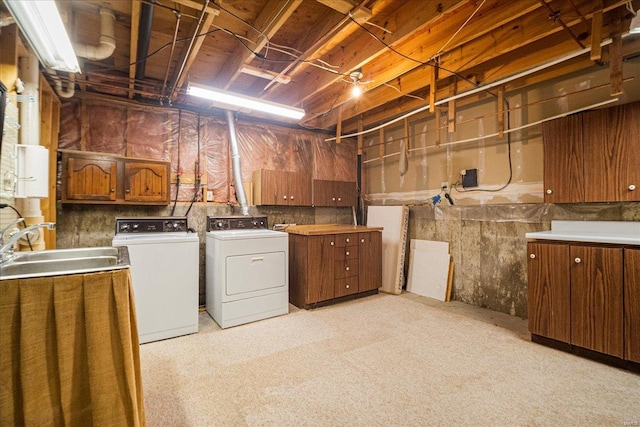 laundry room featuring cabinet space, independent washer and dryer, and a sink