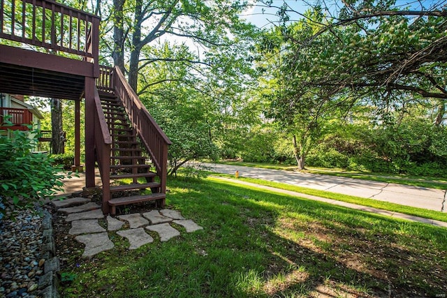 view of yard with stairway and a wooden deck
