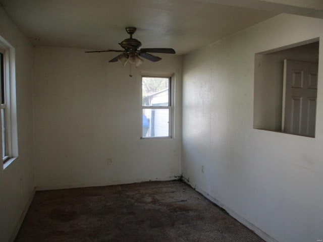 spare room with light colored carpet and ceiling fan