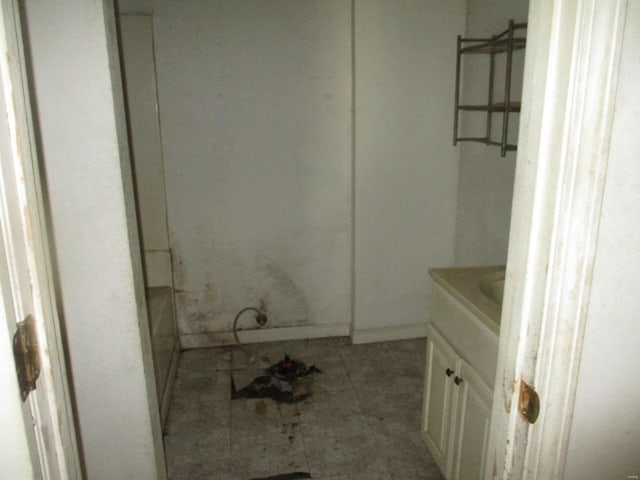 bathroom with vanity and baseboards