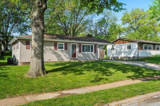 ranch-style home featuring central AC unit and a front lawn