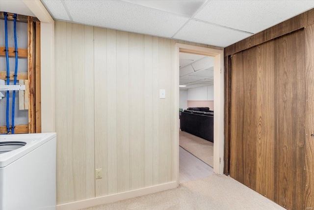 laundry area with washer / clothes dryer, laundry area, wood walls, and carpet