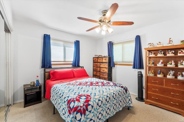 bedroom with baseboards, carpet flooring, ceiling fan, and multiple windows