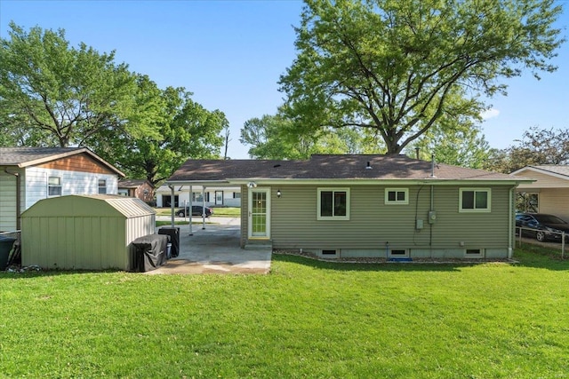 rear view of property with a storage shed, a patio, an outdoor structure, and a lawn
