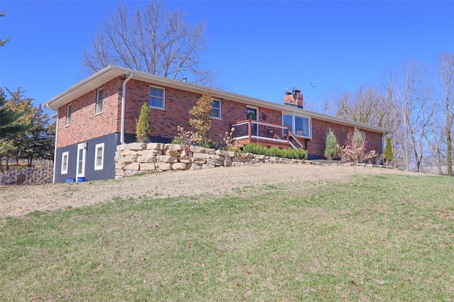 ranch-style house featuring a chimney, a front yard, and brick siding