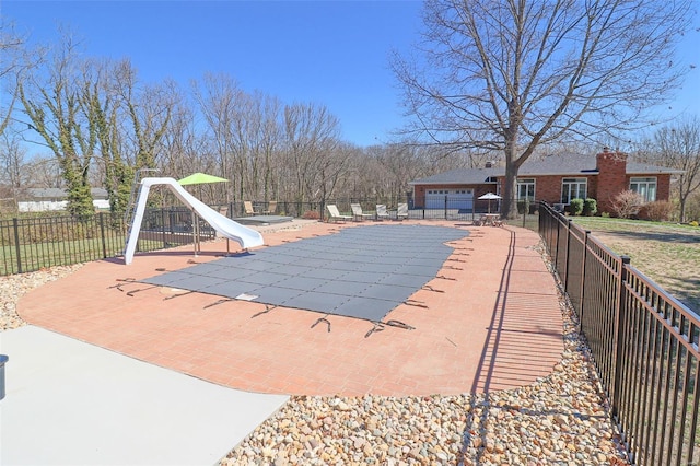 view of pool featuring a water slide, fence, a patio area, and a fenced in pool