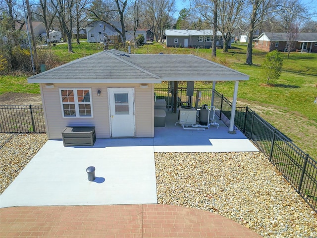 exterior space with a hot tub, fence, and a residential view
