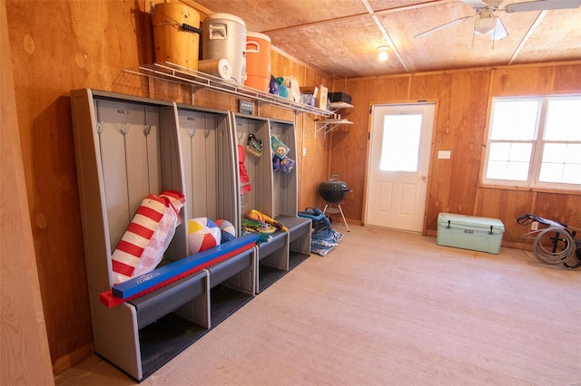 mudroom featuring wooden walls and a ceiling fan