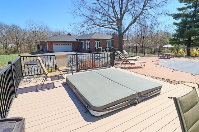 wooden deck with fence and a covered hot tub