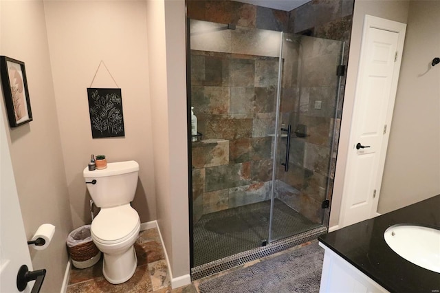 full bathroom featuring vanity, toilet, baseboards, and a stall shower