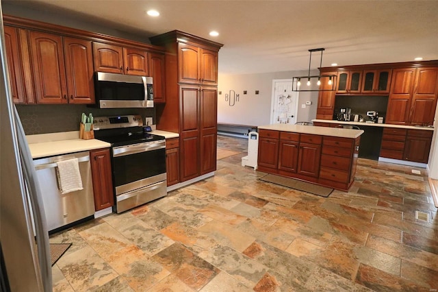 kitchen with light countertops, appliances with stainless steel finishes, and stone tile flooring