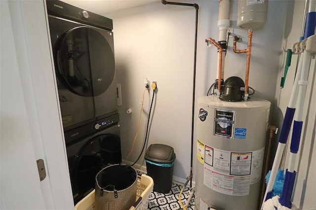 laundry area featuring laundry area, baseboards, stacked washer and clothes dryer, and gas water heater