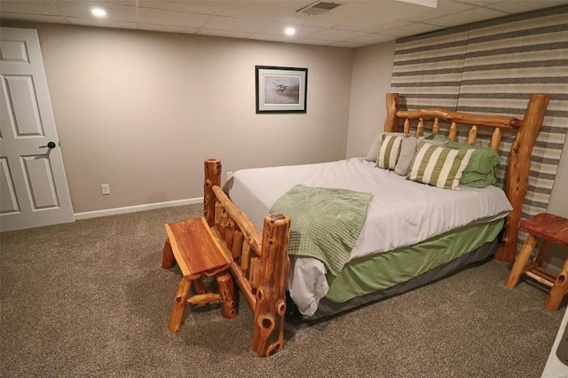 bedroom with visible vents, carpet, baseboards, and a paneled ceiling