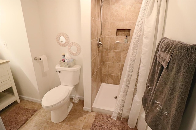bathroom with toilet, baseboards, a shower stall, and tile patterned flooring