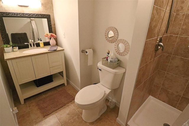 full bathroom featuring vanity, toilet, baseboards, tile patterned floors, and a stall shower