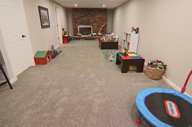 rec room with carpet flooring, recessed lighting, baseboards, and a brick fireplace