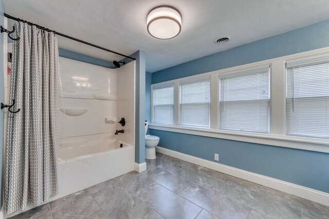 full bathroom with toilet, baseboards, visible vents, and shower / bath combination with curtain