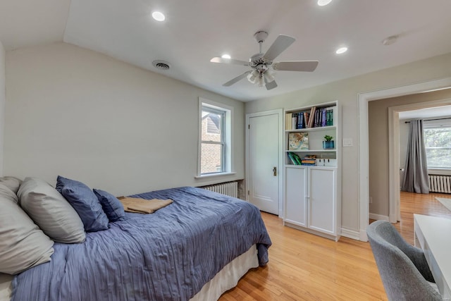 bedroom with visible vents, recessed lighting, radiator, and light wood-style floors