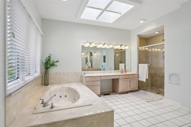 full bathroom with a shower stall, tile patterned floors, vanity, a tub with jets, and a skylight