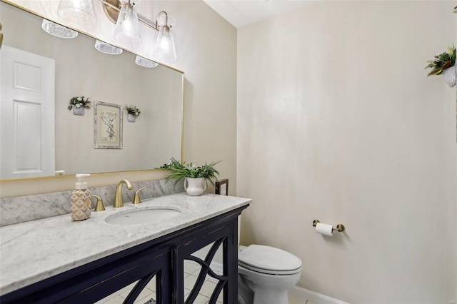 bathroom featuring toilet, baseboards, tile patterned floors, and vanity