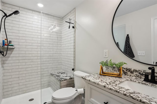 bathroom featuring a stall shower, recessed lighting, vanity, and toilet