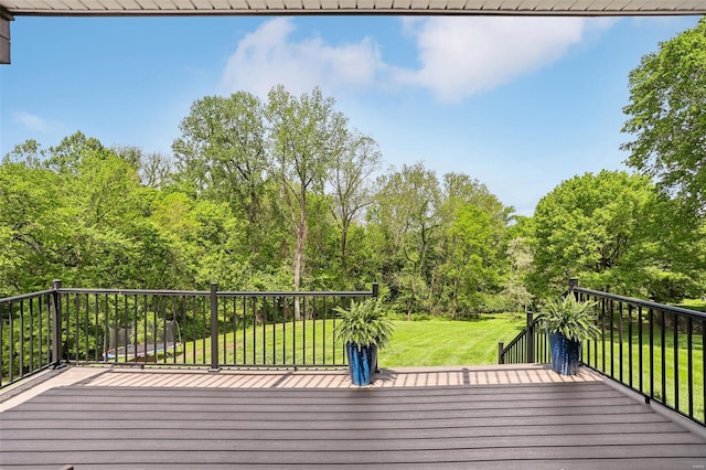 wooden terrace featuring a yard