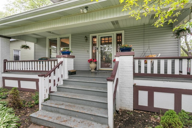 view of exterior entry with a porch