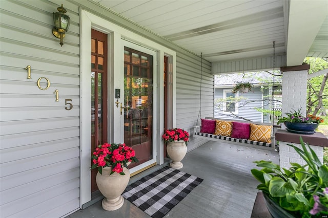 entrance to property featuring a porch