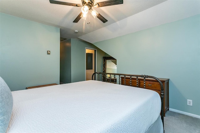 carpeted bedroom with baseboards, a ceiling fan, and lofted ceiling