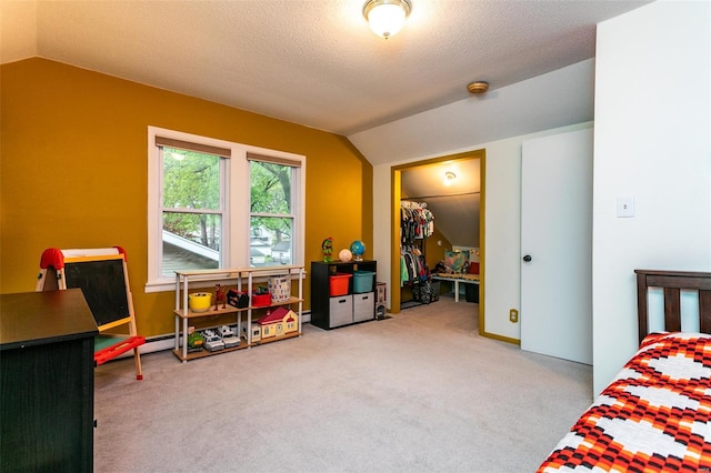 carpeted bedroom featuring vaulted ceiling and a baseboard radiator