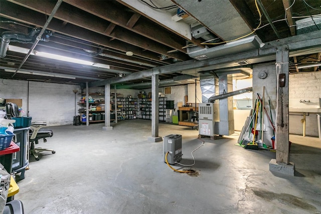 unfinished basement featuring heating unit