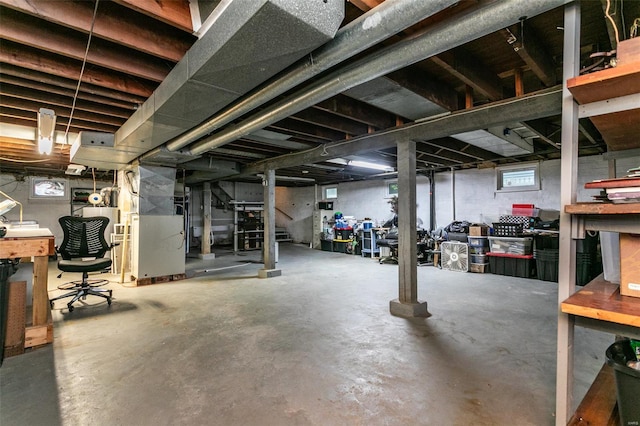 basement with heating unit and a workshop area