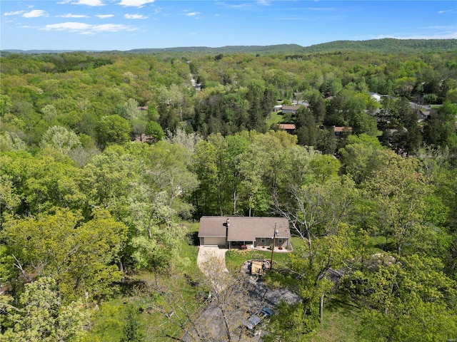 drone / aerial view featuring a wooded view