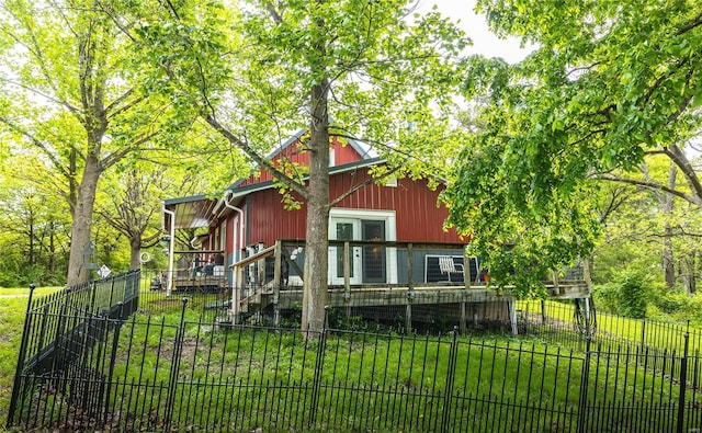 back of house featuring a lawn and a fenced front yard