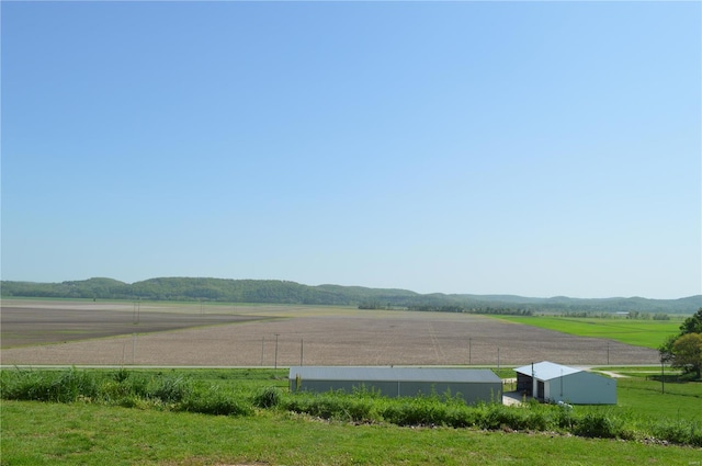 exterior space with a mountain view, an outbuilding, and a rural view