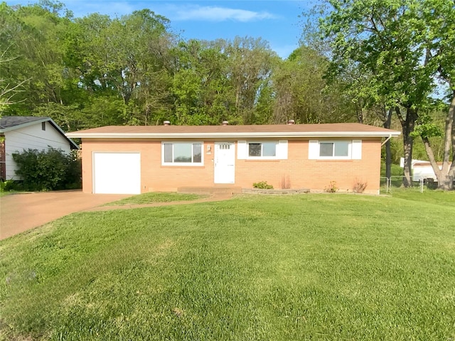 ranch-style house featuring concrete driveway, brick siding, and a front lawn